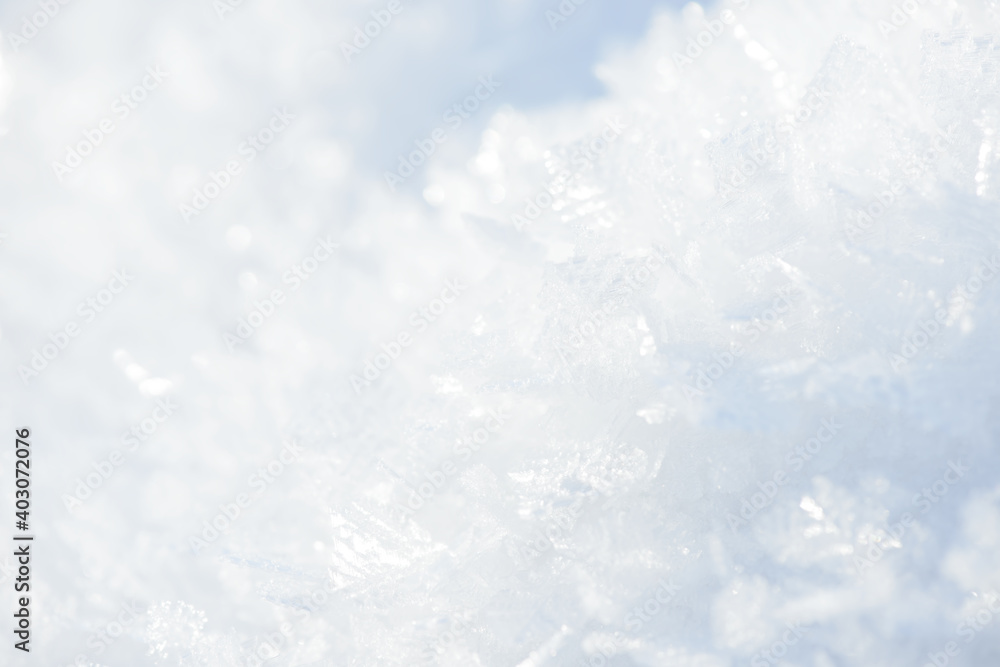 Fototapeta premium Hoarfrost background texture. Fresh ice and snow winter backdrop with snowflakes and mounds. Seasonal wallpaper. Frozen water geometrical shapes and figures. Cold weather atmospheric precipitation.