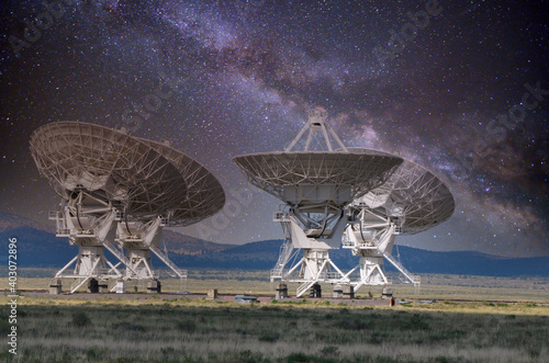 Four antennas that are part of the Very Large Array system in New Mexico, with the Milky Way in the background.