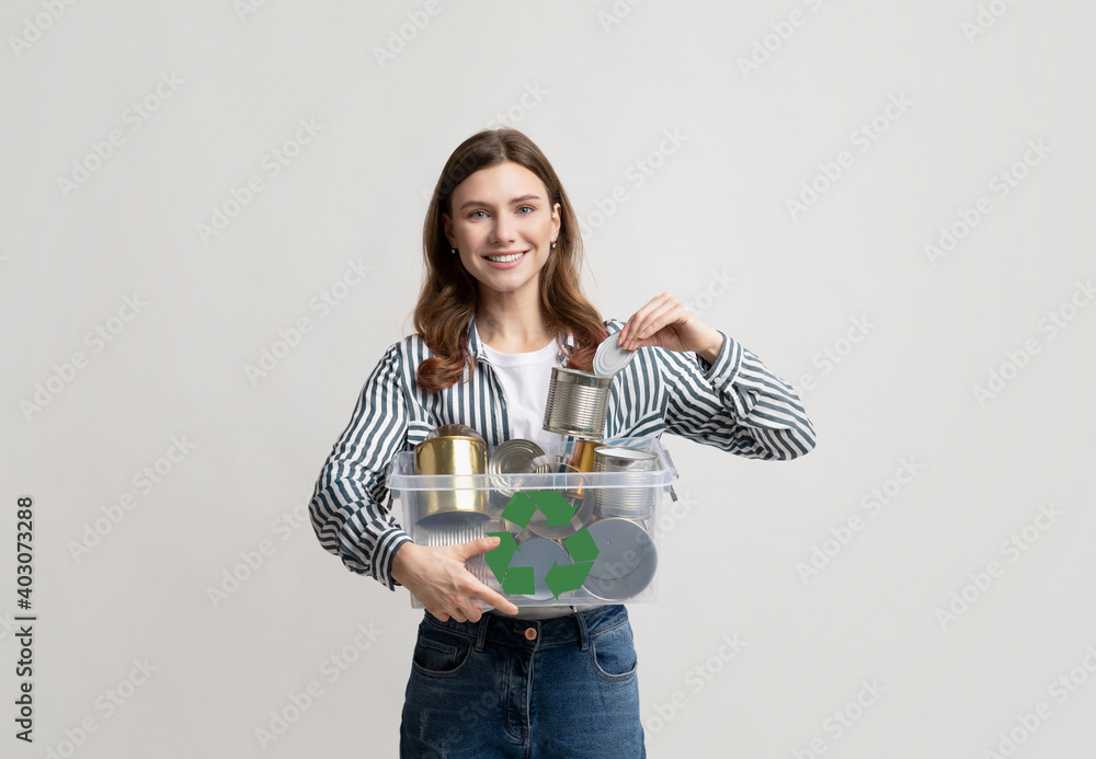 Metal Recycling. Young Smiling Woman Holding Plastic Container Box With Tin Cans Metal Recycling. Young Smiling Woman Holding Plastic Container Box With Tin Cans