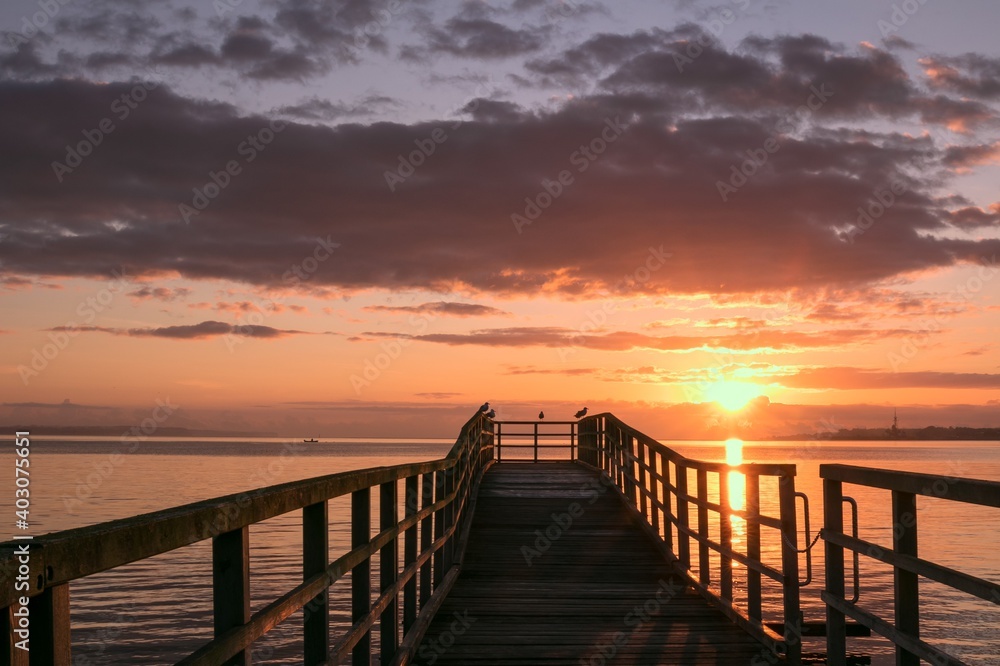 Fototapeta premium pier at sunset, sea texture