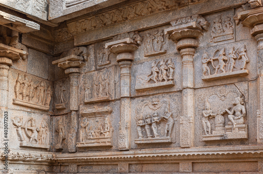 Hampi, Karnataka, India - November 4, 2013: Hazara Rama Temple. group of Frescoes on beige stone walls of building.