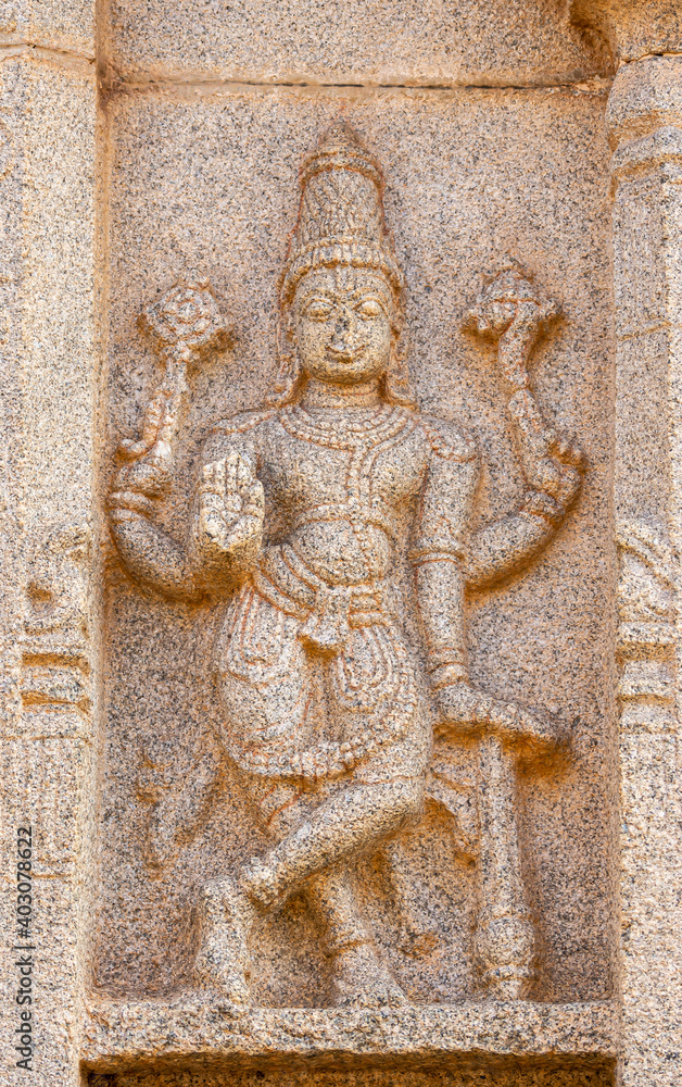Hampi, Karnataka, India - November 4, 2013: Hazara Rama Temple. Closeup of beige stone sculptures of Vishnu as Rama.