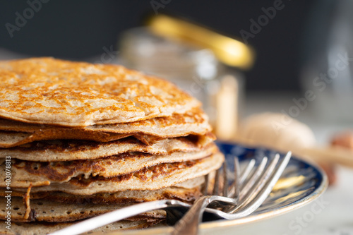 buckwheat pancakes with honey on a vintage plate