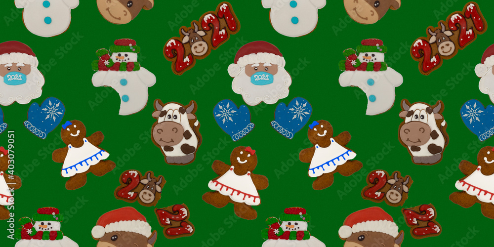 Christmas gingerbread on a green background. Seamless repeating pattern with brown homemade cookies in colored icing sugar. New year ornament handmade decoration.