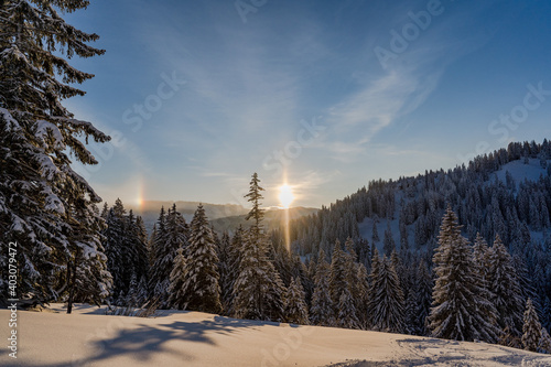 Sonnenuntergang vor verschneiter Berglandschaft in Grasgehren im Allgäu. Der Hohe Ifen im Hintergrund photo