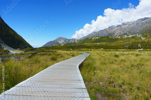 Wooden section of Hooker Valley walkway between mountains towards Mount Cook