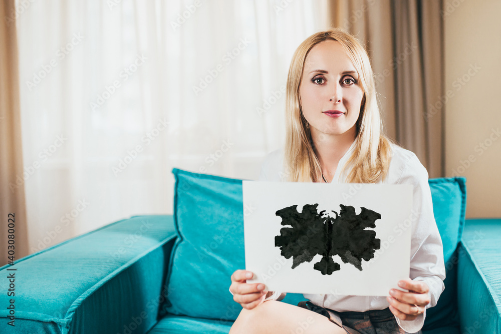 Minsk, Belarus - July 07, 2020: Beautiful elegant woman psychologist blonde holds a sheet with a Rorschach test in her hands - a psychodiagnostic test to study personality of a Rorschach spot Minsk, Belarus - July 07, 2020: Beautiful elegant woman psychologist blonde holds a sheet with a Rorschach test in her hands - a psychodiagnostic test to study personality of a Rorschach spot