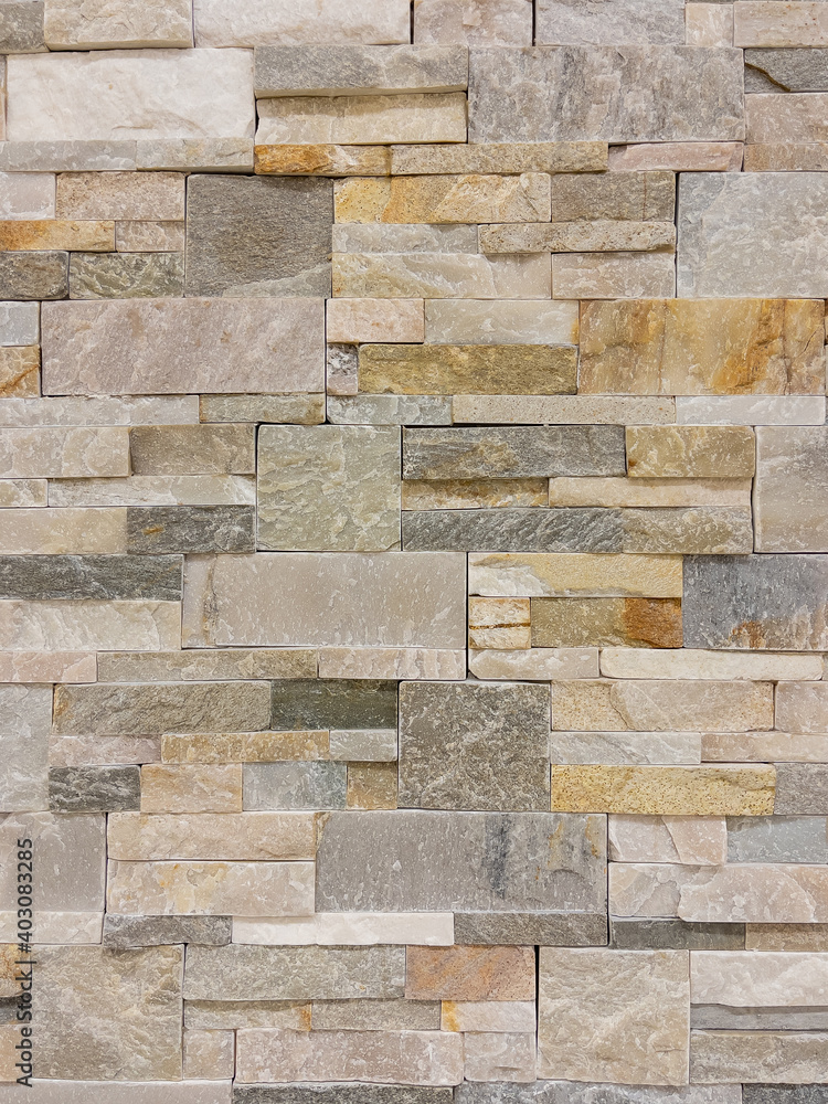 Naklejka Texture - tiles for floor and wall imitating a wall of hewn uneven stone assembly of various shapes