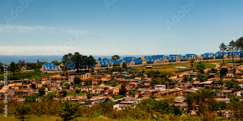 Township in the foreground and settlement with blue roofs in the background near Port Elisabeth, South Africa