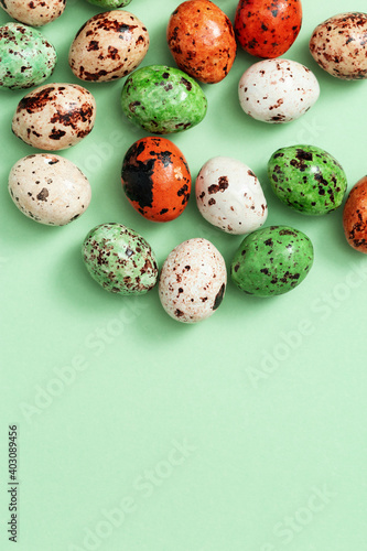 Colorful Easter Quail eggs. Spring Easter composition with chocolate candy.