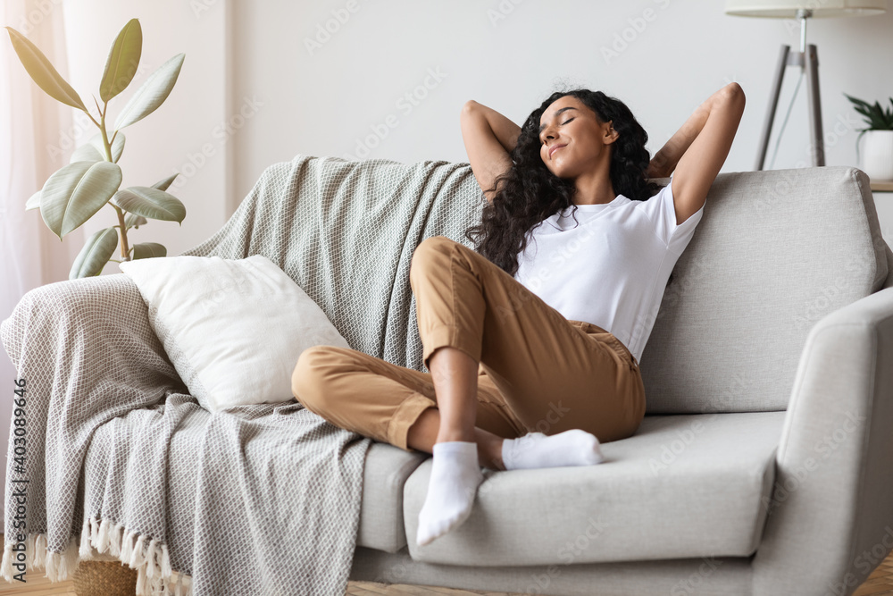 Carefree young woman resting on couch at home Carefree young woman resting on couch at home