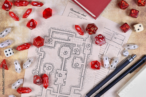 Roleplaying game dices on hand drawn dungeon adventure map. Concept for table top role playing games