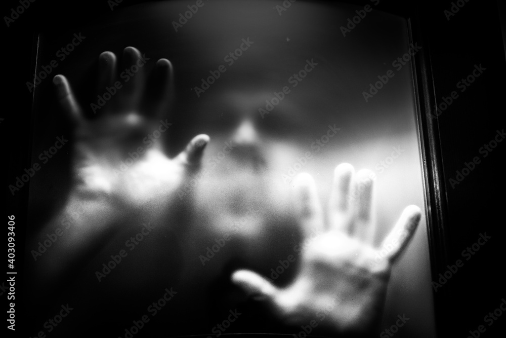scary picture of hands behind glass