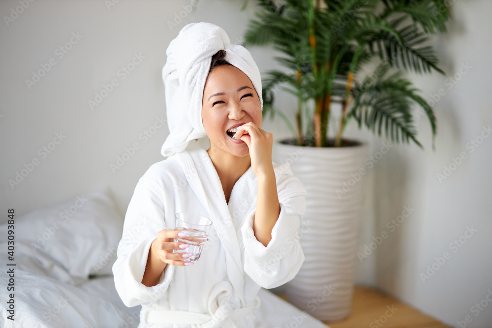 female taking pills and a glass of water for treatment, in the morning. nice woman drinks vitamins for disease prevention. wellness and health concept female taking pills and a glass of water for treatment, in the morning. nice woman drinks vitamins for disease prevention. wellness and health concept