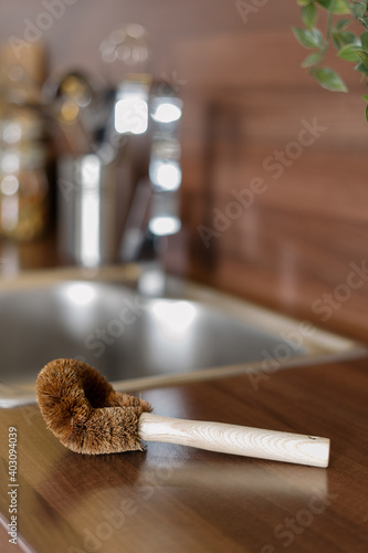 Coconut brush lying on wooden kitchen table