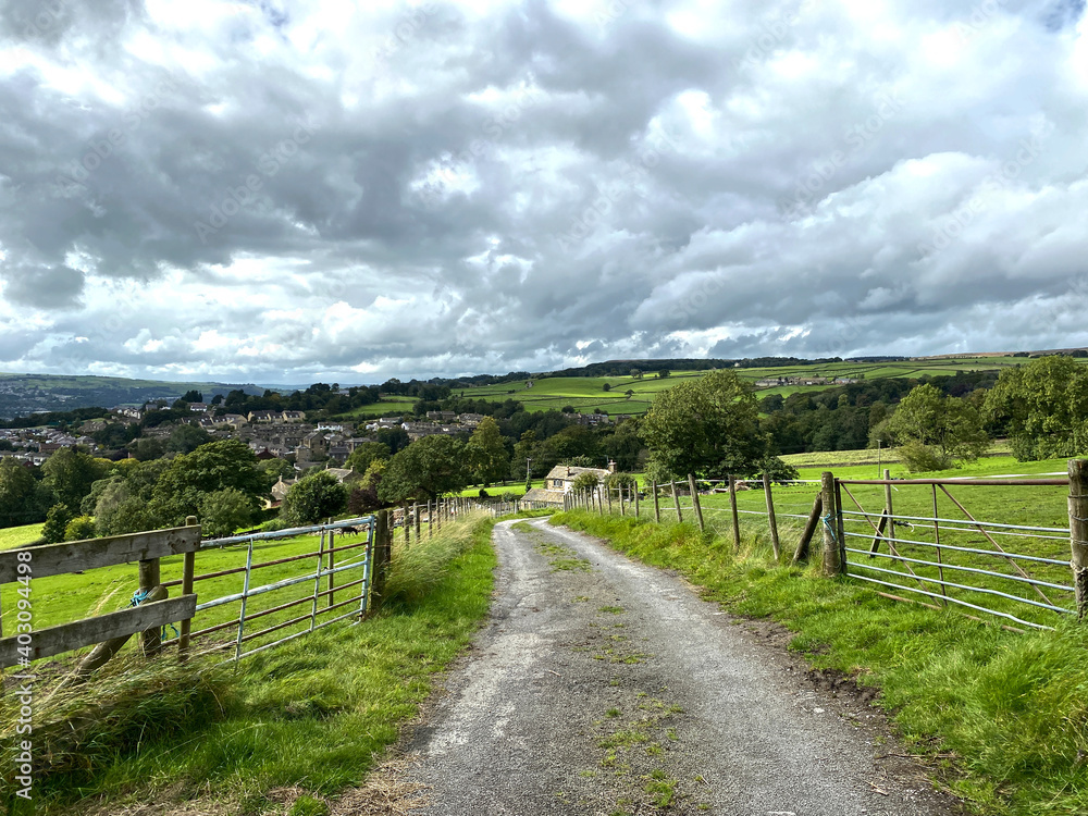 Rural landscape, with fields, trees, and heavy rain clouds near, East Morton, Keighley, UK