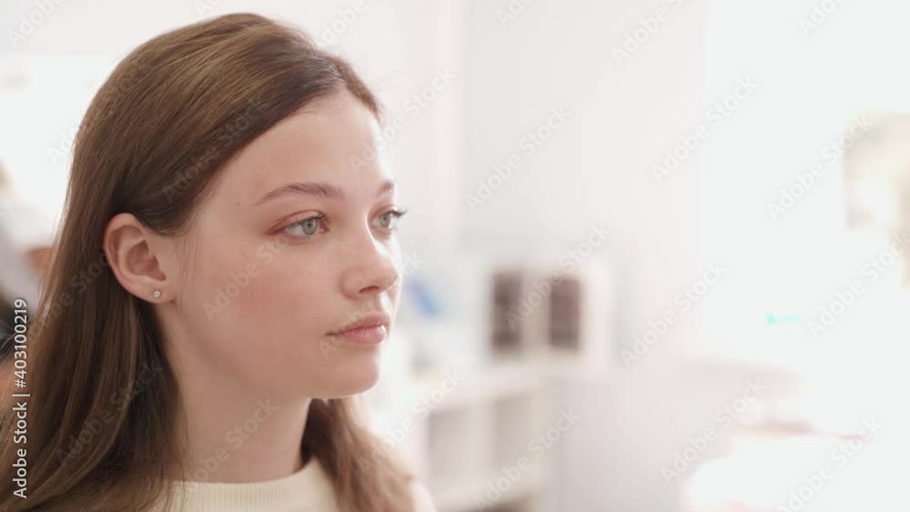 Eyebrow correction. The brow master plucks the hairs on the eyebrows with tweezers. Eyebrow correction. The brow master plucks the hairs on the eyebrows with tweezers.