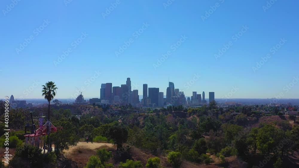 Drone shot panning right at Elysian Park showing the LA Skyline in the background with clear blue sky and no clouds. Drone shot panning right at Elysian Park showing the LA Skyline in the background with clear blue sky and no clouds.