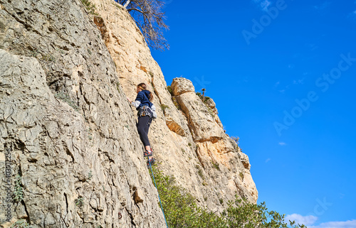 Horizontal photo of a young climber climbing the mountain in a beautiful place