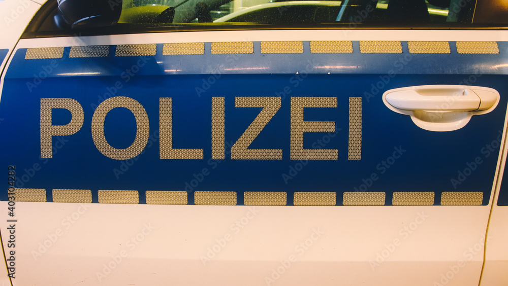 Police sign in white letters on a police car