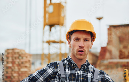 Portrait of construction worker in uniform and safety equipment