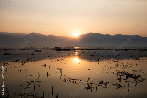 beautiful sunrise of inle lake in myanmar with sun