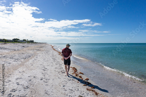 Man looks out at the ocean, Gasparilla beach Florida