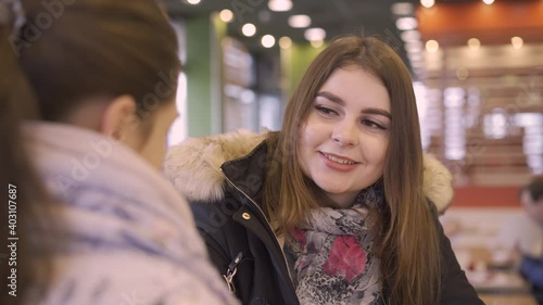 two women chatting in fast food cafe