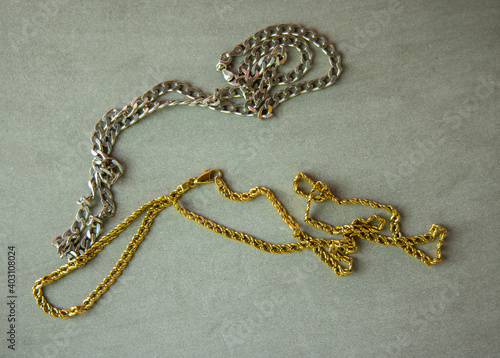 a gold necklace and a silver necklace