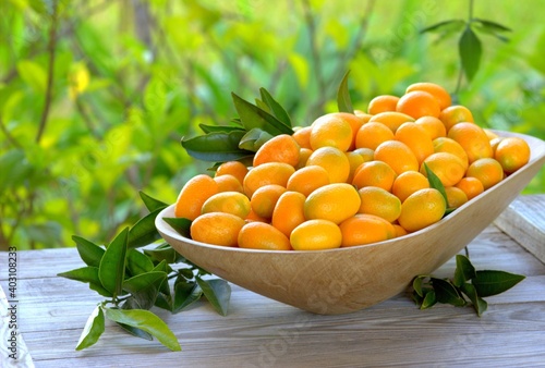 Fresh kumquats in a dish. Citrus background. 

