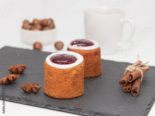 Runeberg Cakes (Runebergin Torttu) - traditional Finnish homemade pastry on a slate board, close-up. Runeberg day. photo