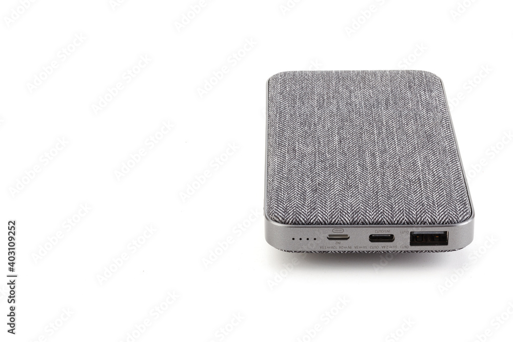 Additional self-contained external battery for charging mobile devices and other devices. Power bank isolated on white background. Stylish fabric charger (rechargeable battery). Full depth of field. Additional self-contained external battery for charging mobile devices and other devices. Power bank isolated on white background. Stylish fabric charger (rechargeable battery). Full depth of field.