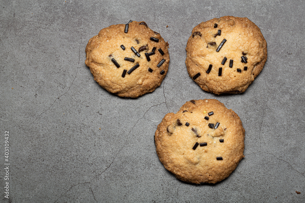 Some artisan homemade chocolate biscuit cookies close up still on a grey background Some artisan homemade chocolate biscuit cookies close up still on a grey background