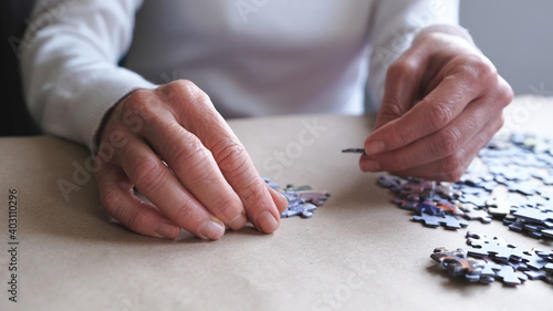 middle-aged woman doing puzzle for dementia.