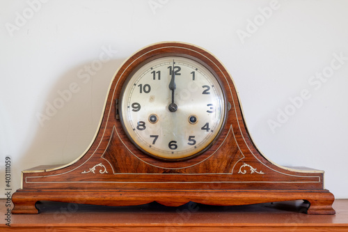 Close up of an antique clock showing 12 oclock photo