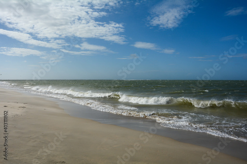 Sea and waves with  sand beach and blue sky
