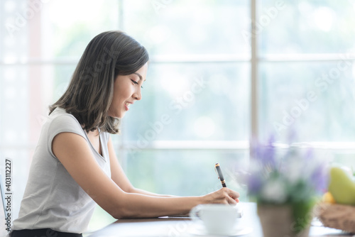 young Asian woman smiling t...