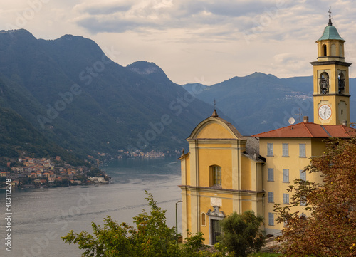 Como lake and the picturesque yellow church of Pognana Lario.Lombardy, Italian Lakes, Italy. photo