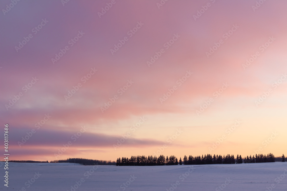 sunset over snow covered field