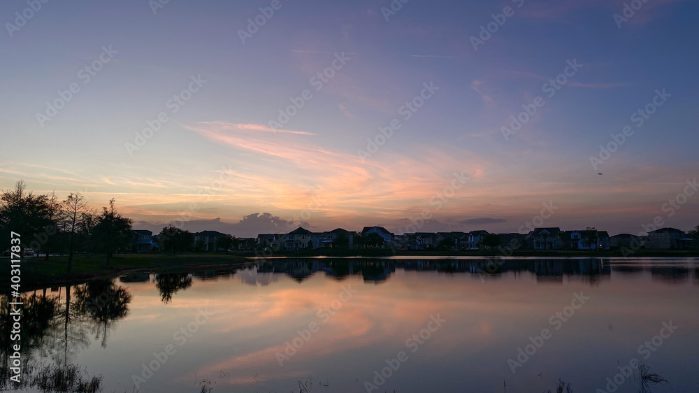 Beautiful pink, orange and blue sunset reflecting on a lake.