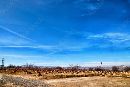 View of the landscape in the Cappadocia valley with mountains in the distance on the horizon and blue sky