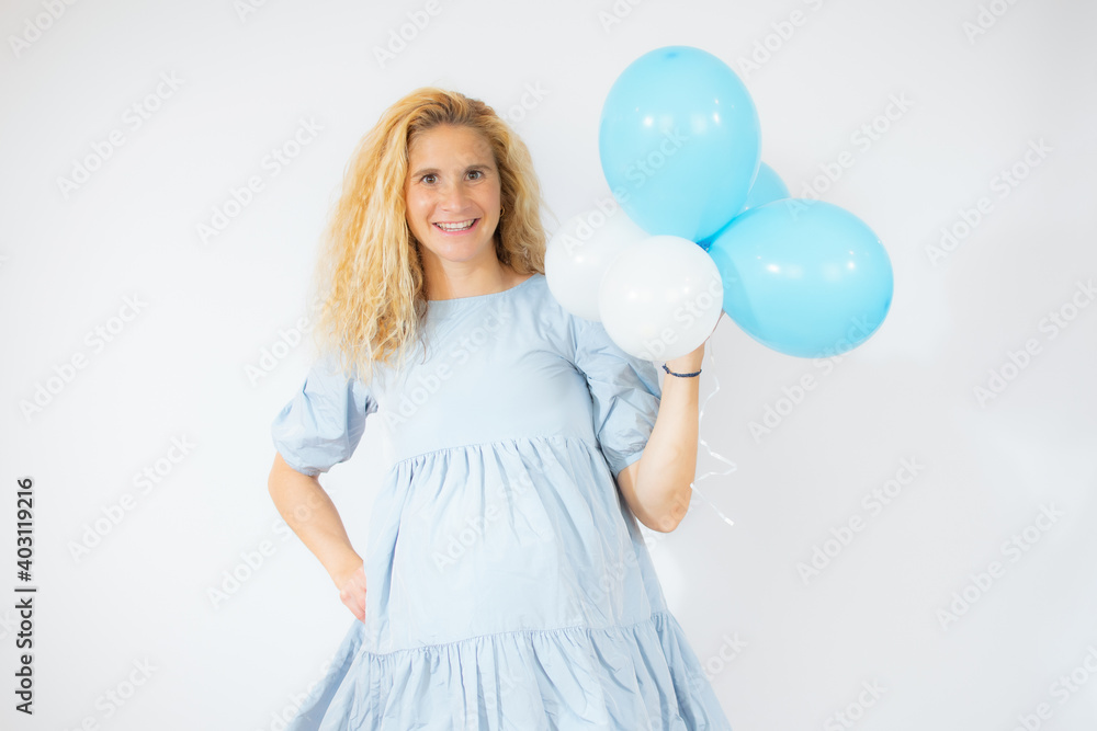 joyful and pregnant woman in blue dress holding balloons isolated on white joyful and pregnant woman in blue dress holding balloons isolated on white