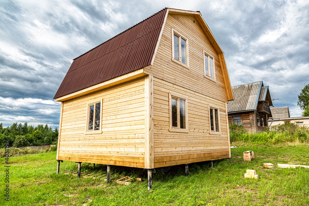 New small wooden house under construction at the village New small wooden house under construction at the village
