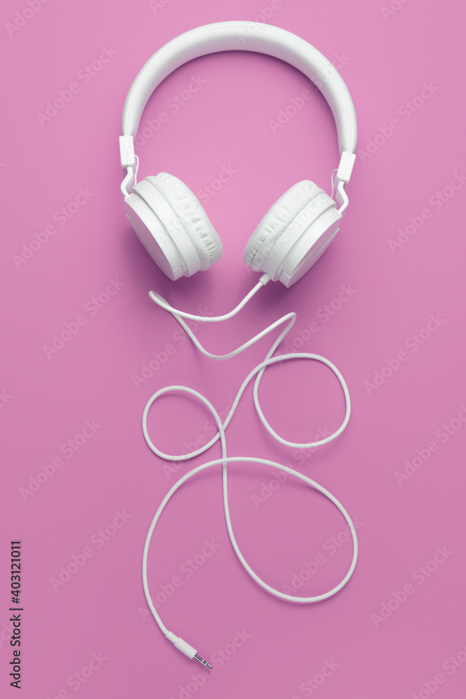 Cool white headphone on pink background. Music concept. Cool white headphone on pink background. Music concept.