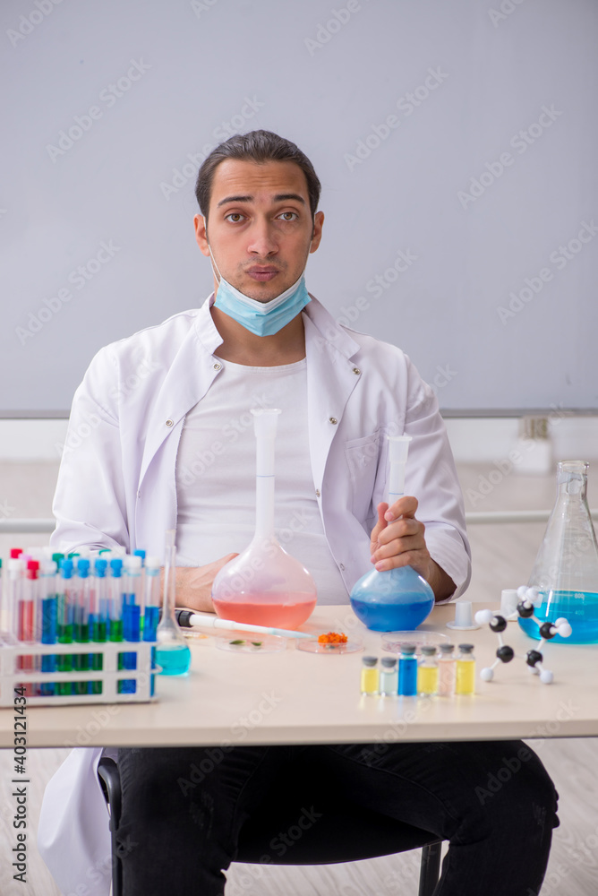 Young male chemist working in the lab Young male chemist working in the lab
