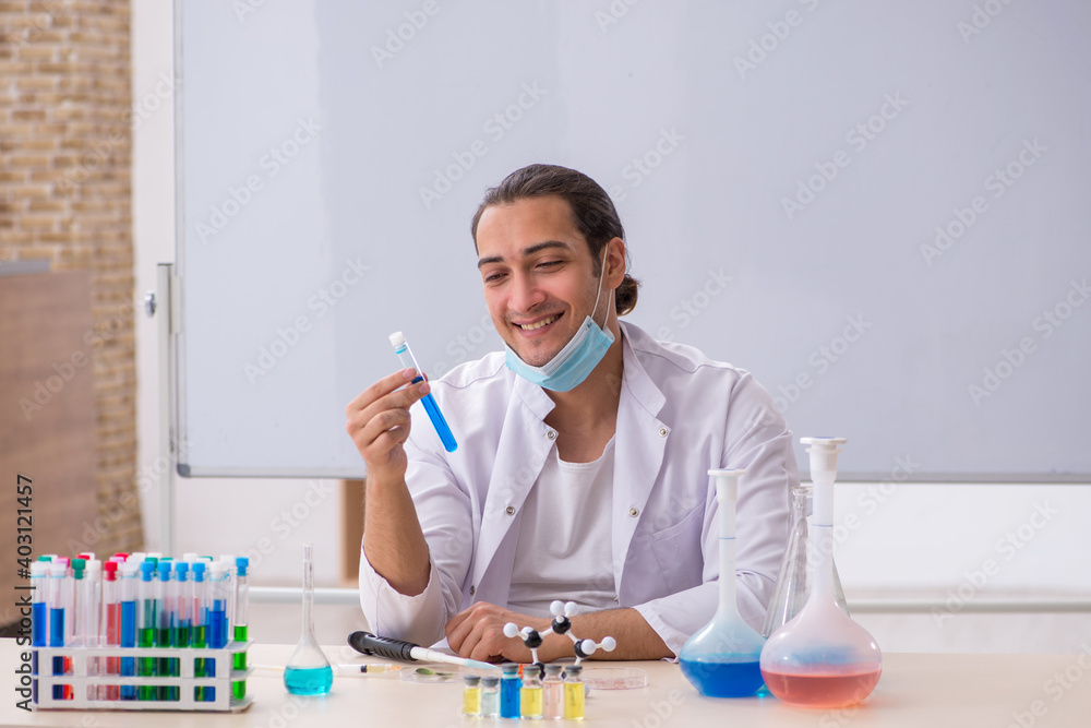 Young male chemist working in the lab Young male chemist working in the lab