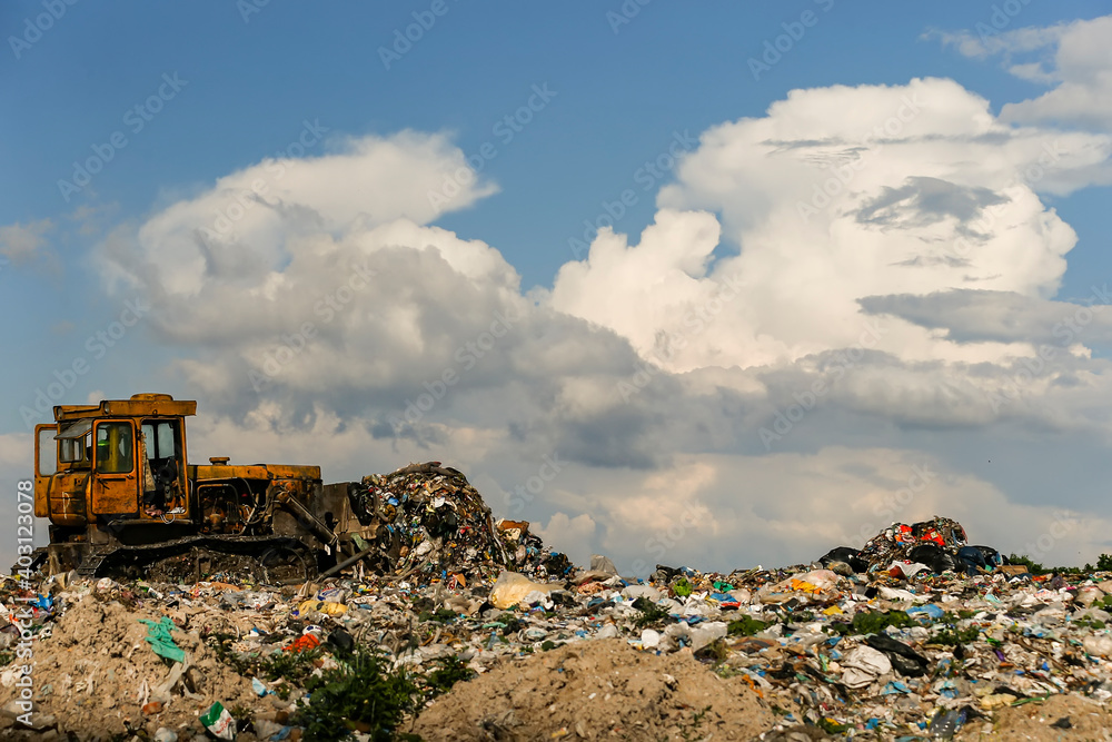 Seagulls fly over piles of garbage. A bulldozer tractor works at a large landfill near Kyiv, Ukraine. May 2016 Seagulls fly over piles of garbage. A bulldozer tractor works at a large landfill near Kyiv, Ukraine. May 2016