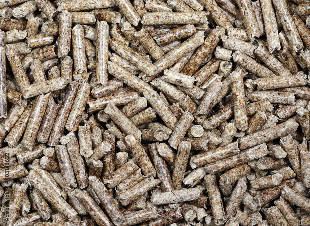 Close up on a pile of compressed wood pellets for use as an eco-friendly renewable organic biofuel or mulch in the garden over a white background Close up on a pile of compressed wood pellets for use as an eco-friendly renewable organic biofuel or mulch in the garden over a white background