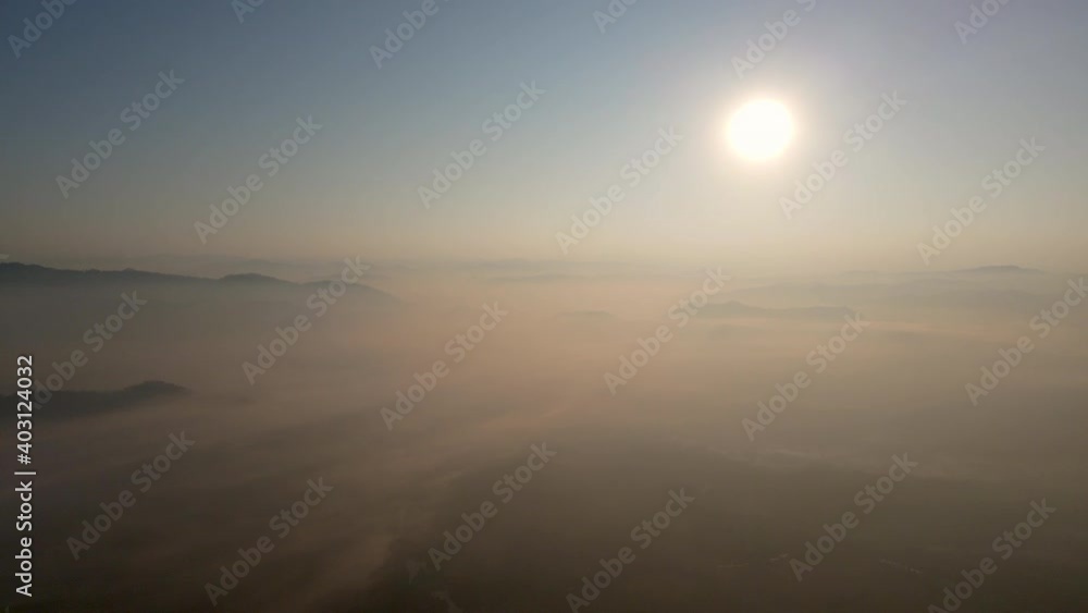 Aerial View. Flying in fog, fly in mist. Aerial camera shot. Flight above the clouds towards the sun. Misty weather Aerial View. Flying in fog, fly in mist. Aerial camera shot. Flight above the clouds towards the sun. Misty weather