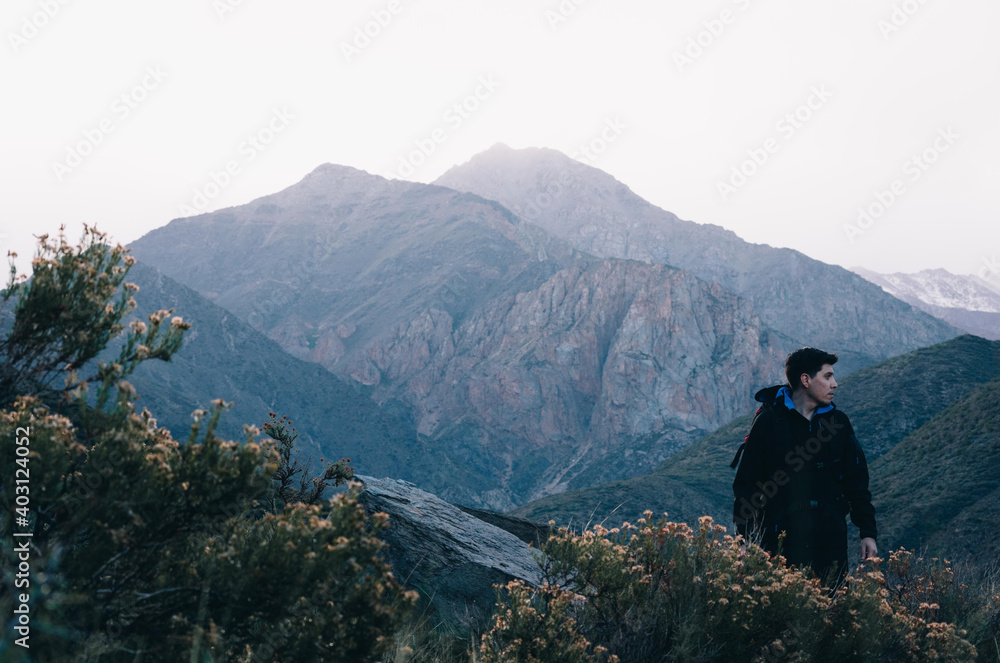 young adult looking at the Andes mountain range in Argentina
